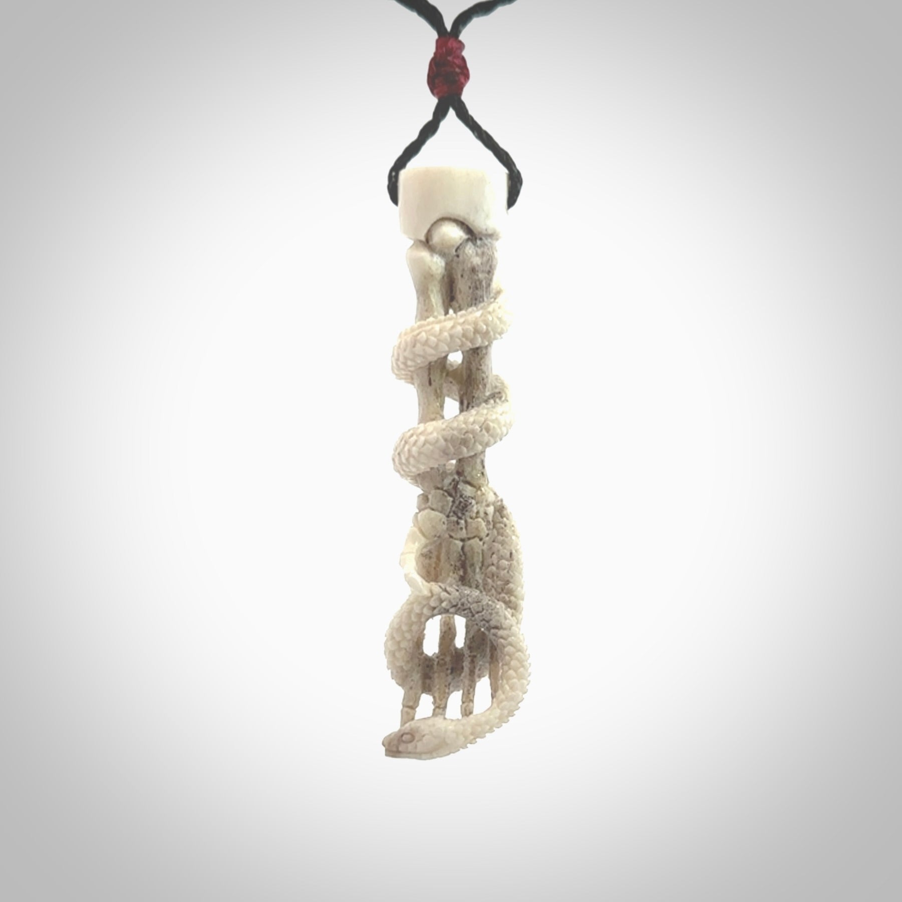 Hand carved deer antler skeleton hand with snake pendant. Hand carved by NZ Pacific. Free postage worldwide. Hand made skeleton hand with snake necklace from deer antler. Skeleton hand with snake necklace for men and women.