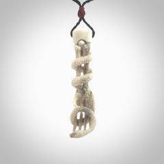 Hand carved deer antler skeleton hand with snake pendant. Hand carved by NZ Pacific. Free postage worldwide. Hand made skeleton hand with snake necklace from deer antler. Skeleton hand with snake necklace for men and women.