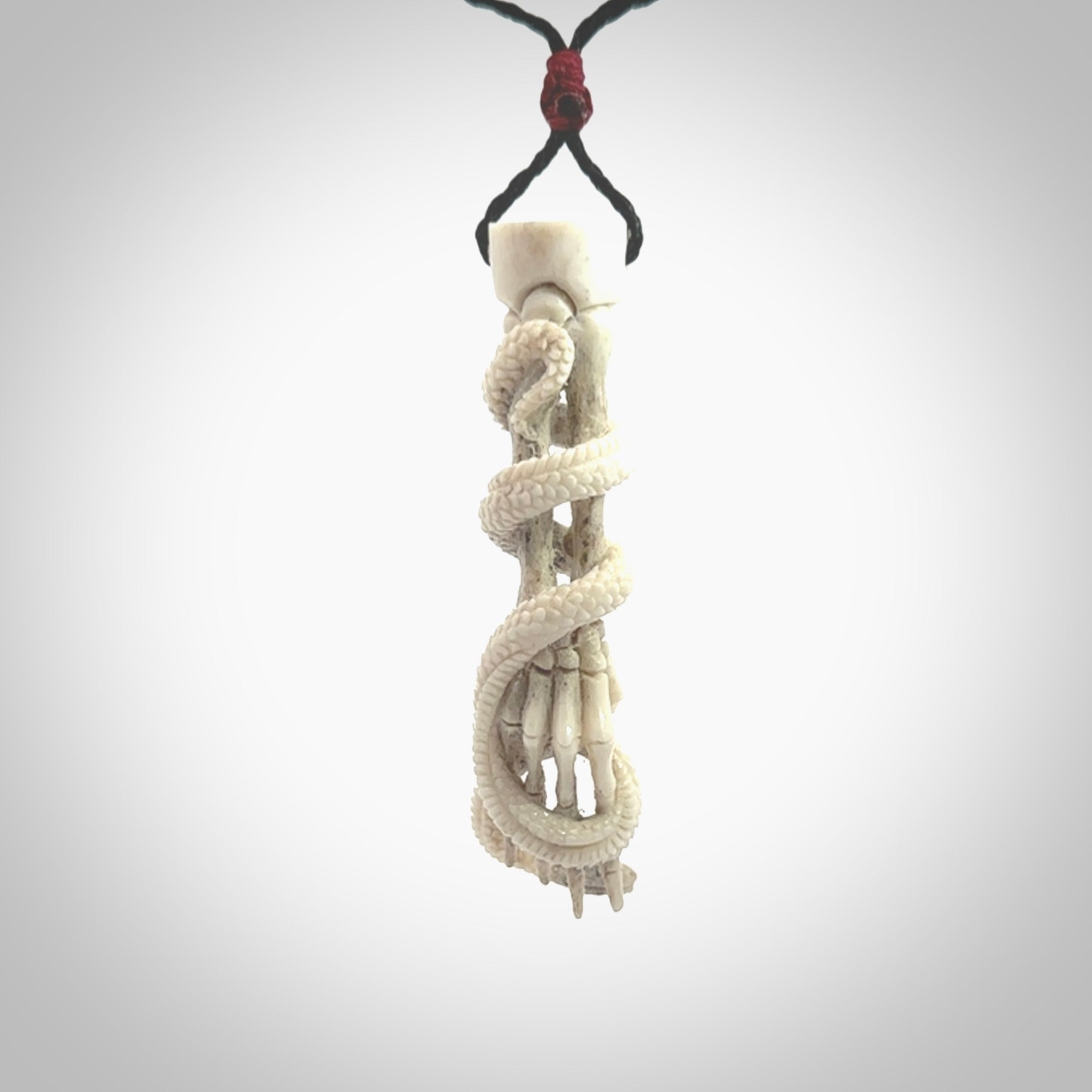 Hand carved deer antler skeleton hand with snake pendant. Hand carved by NZ Pacific. Free postage worldwide. Hand made skeleton hand with snake necklace from deer antler. Skeleton hand with snake necklace for men and women.