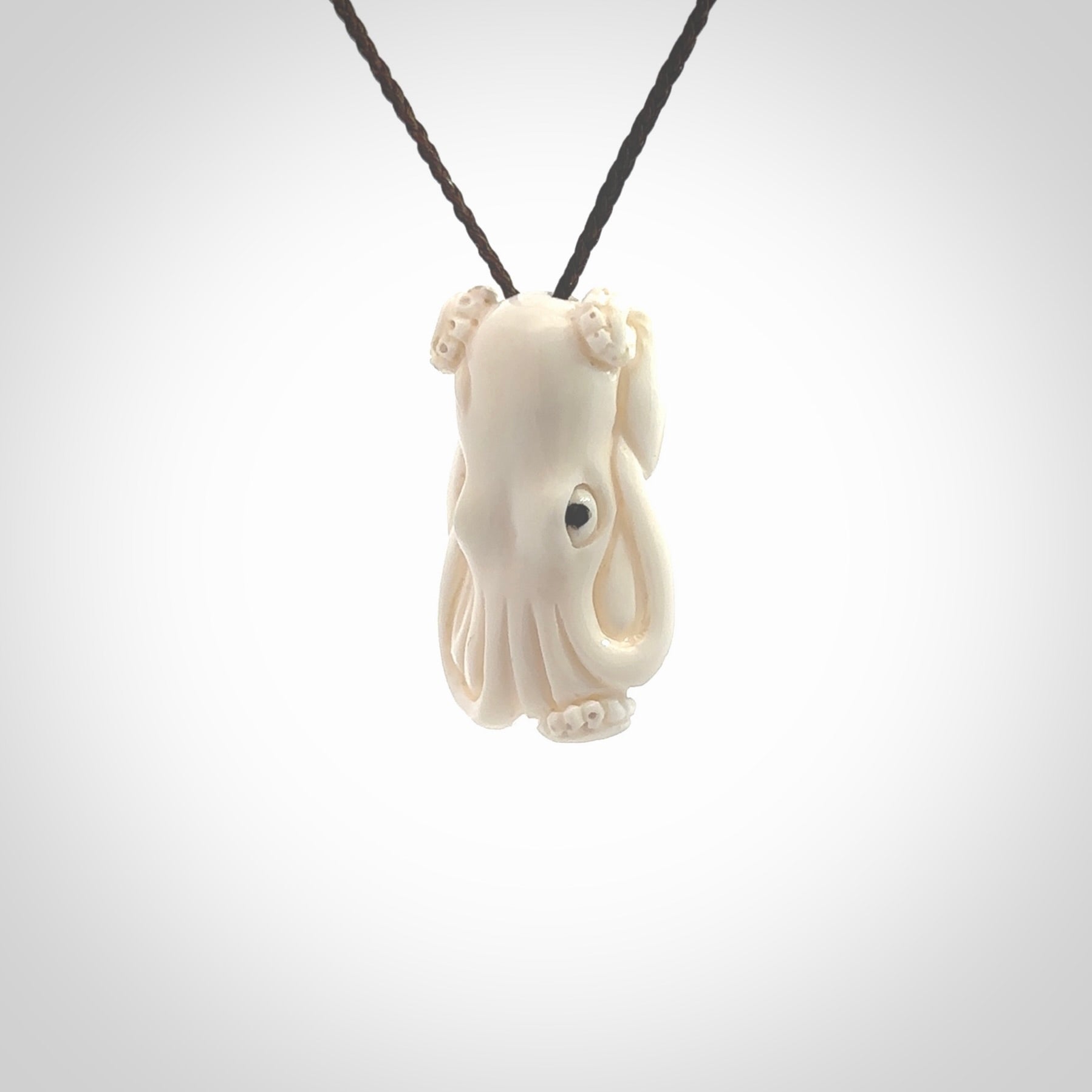 This is a beautiful little hand carved octopus pendant. It is a very cute little pendant that we have carved in natural, untreated bone. We provide these with blue or brown adjustable cords and shipping is included worldwide so there are no hidden costs when you reach checkout. Hand carved jewellery by NZ Pacific for sale online.