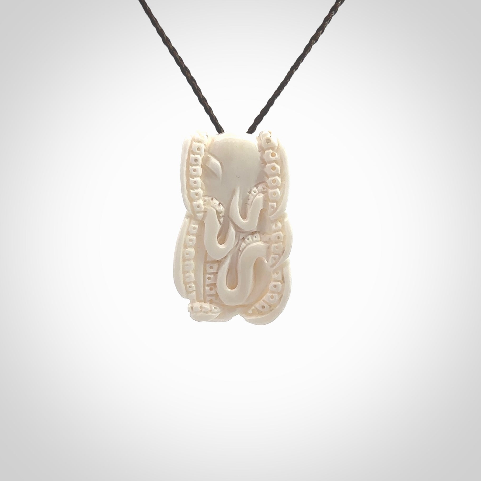 This is a beautiful little hand carved octopus pendant. It is a very cute little pendant that we have carved in natural, untreated bone. We provide these with blue or brown adjustable cords and shipping is included worldwide so there are no hidden costs when you reach checkout. Hand carved jewellery by NZ Pacific for sale online.