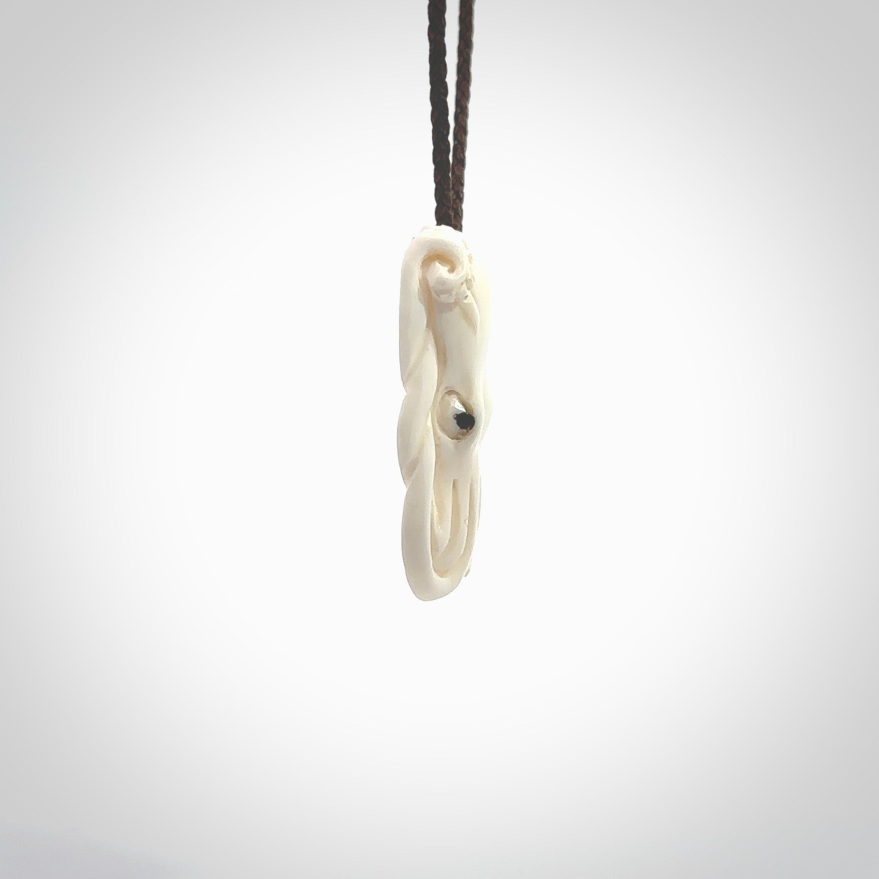 This is a beautiful little hand carved octopus pendant. It is a very cute little pendant that we have carved in natural, untreated bone. We provide these with blue or brown adjustable cords and shipping is included worldwide so there are no hidden costs when you reach checkout. Hand carved jewellery by NZ Pacific for sale online.