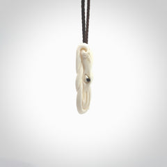 This is a beautiful little hand carved octopus pendant. It is a very cute little pendant that we have carved in natural, untreated bone. We provide these with blue or brown adjustable cords and shipping is included worldwide so there are no hidden costs when you reach checkout. Hand carved jewellery by NZ Pacific for sale online.