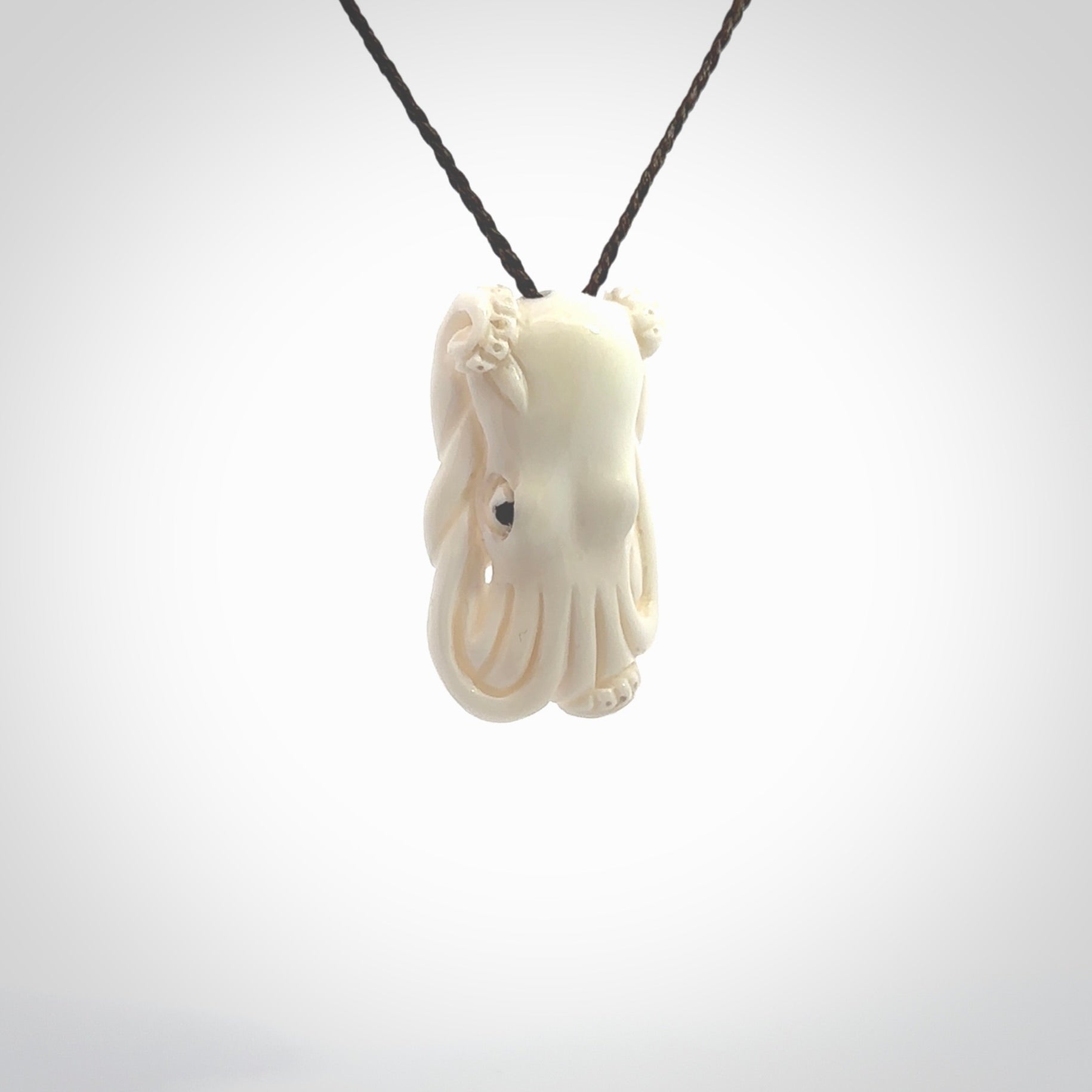 This is a beautiful little hand carved octopus pendant. It is a very cute little pendant that we have carved in natural, untreated bone. We provide these with blue or brown adjustable cords and shipping is included worldwide so there are no hidden costs when you reach checkout. Hand carved jewellery by NZ Pacific for sale online.