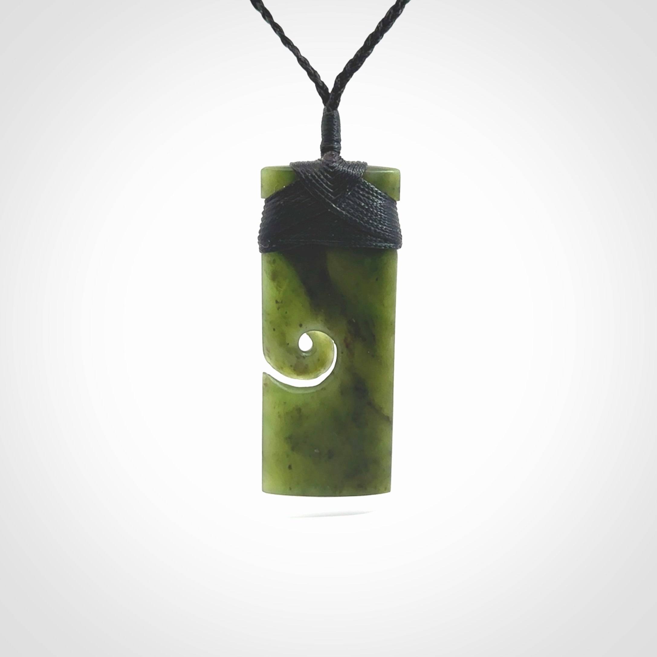 New Zealand jade toki koru pendant. Hand carved in New Zealand. Hand made New Zealand Jade jewellery. Provided with an adjustable cord and packaged in a woven kete pouch.