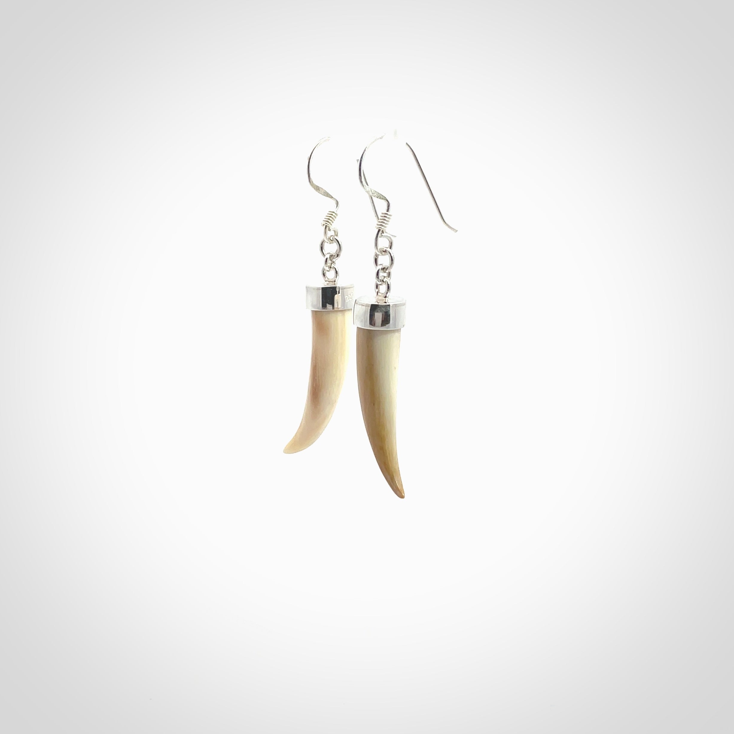 Hand made mammoth tusk drop earrings. Made by NZ Pacific - handmade jewellery for sale online. Woolly Mammoth Tusk fang style earrings, packaged in a woven kete pouch.