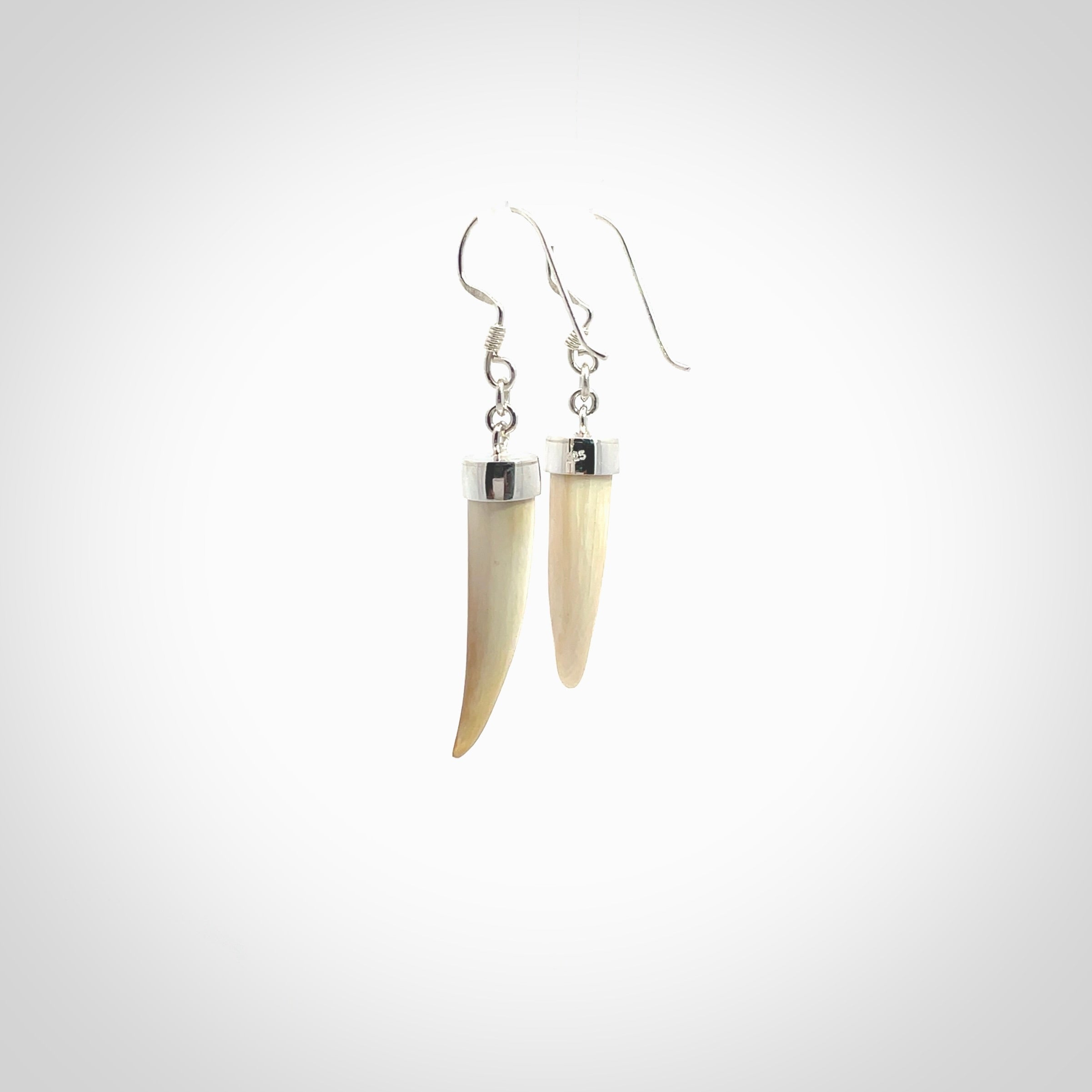 Hand made mammoth tusk drop earrings. Made by NZ Pacific - handmade jewellery for sale online. Woolly Mammoth Tusk fang style earrings, packaged in a woven kete pouch.