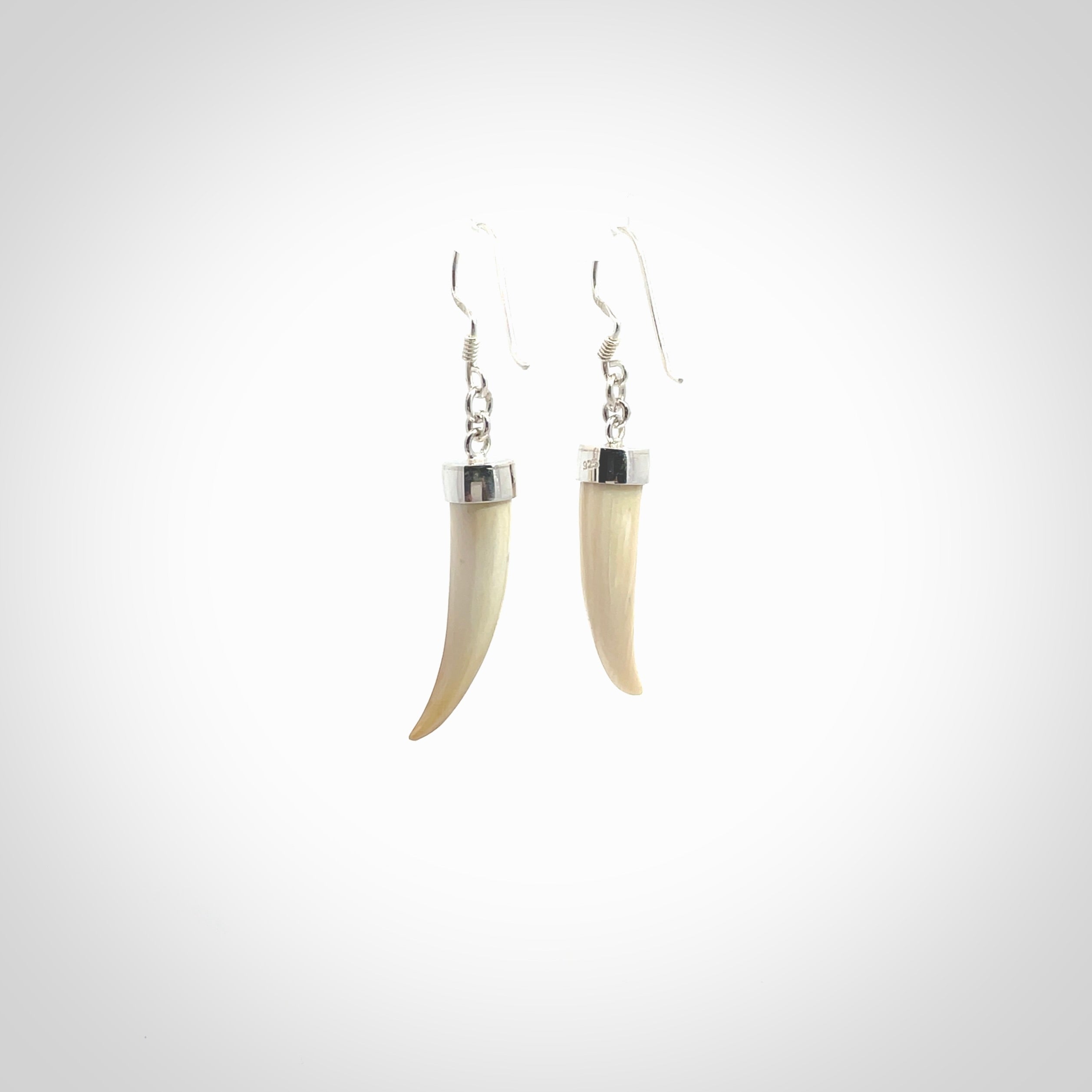 Hand made mammoth tusk drop earrings. Made by NZ Pacific - handmade jewellery for sale online. Woolly Mammoth Tusk fang style earrings, packaged in a woven kete pouch.