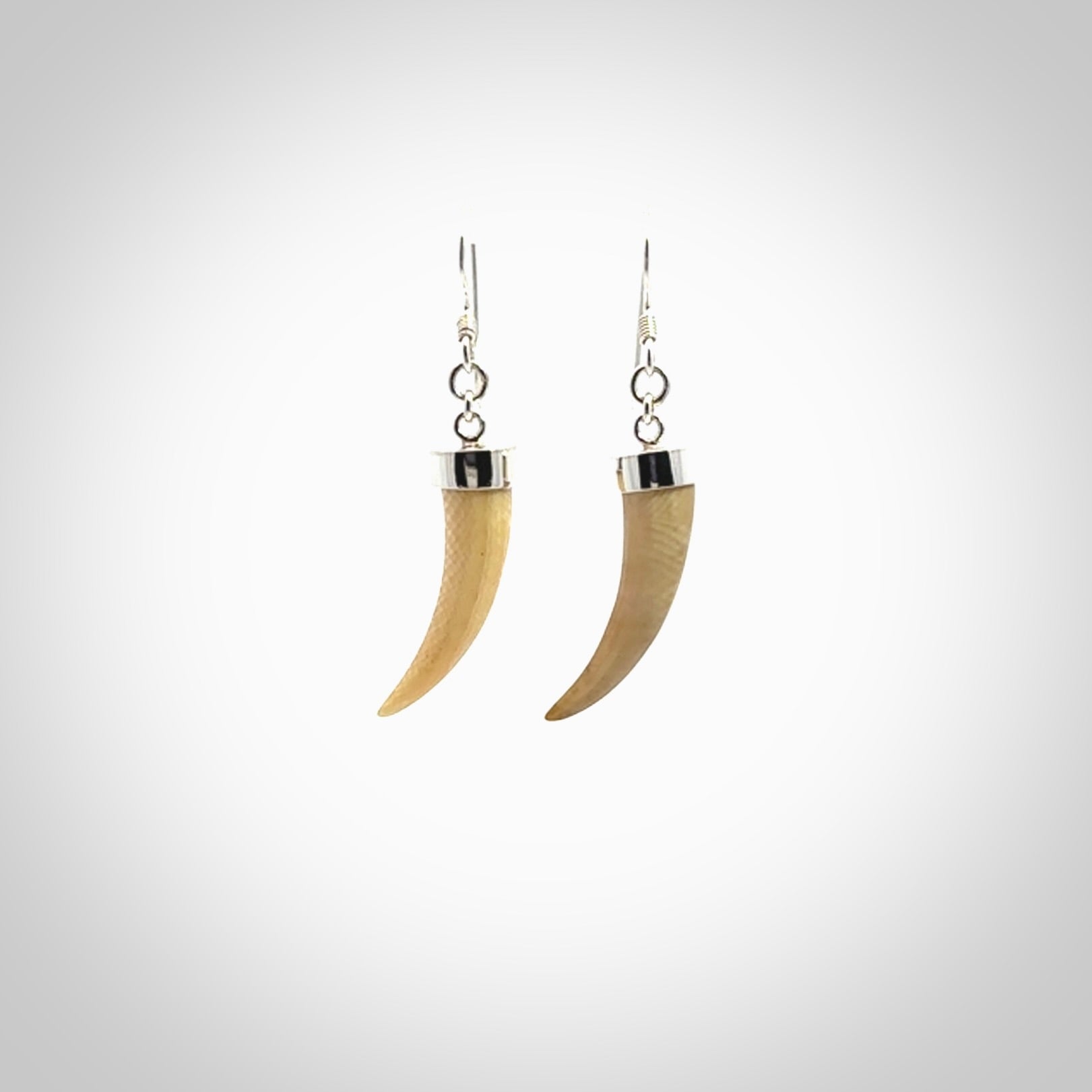 Hand made mammoth tusk drop earrings. Made by NZ Pacific - handmade jewellery for sale online. Woolly Mammoth Tusk fang style earrings, packaged in a woven kete pouch.