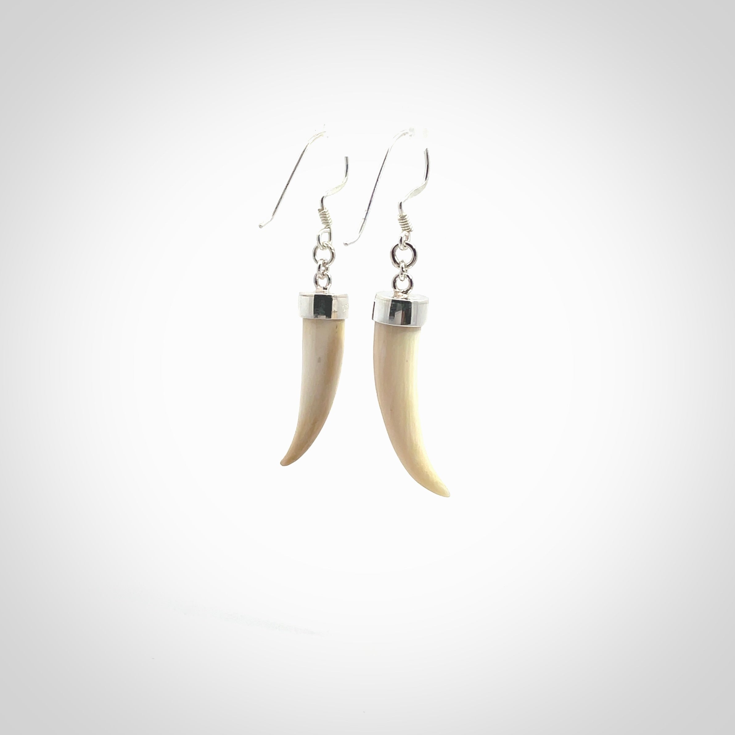 Hand made mammoth tusk drop earrings. Made by NZ Pacific - handmade jewellery for sale online. Woolly Mammoth Tusk fang style earrings, packaged in a woven kete pouch.