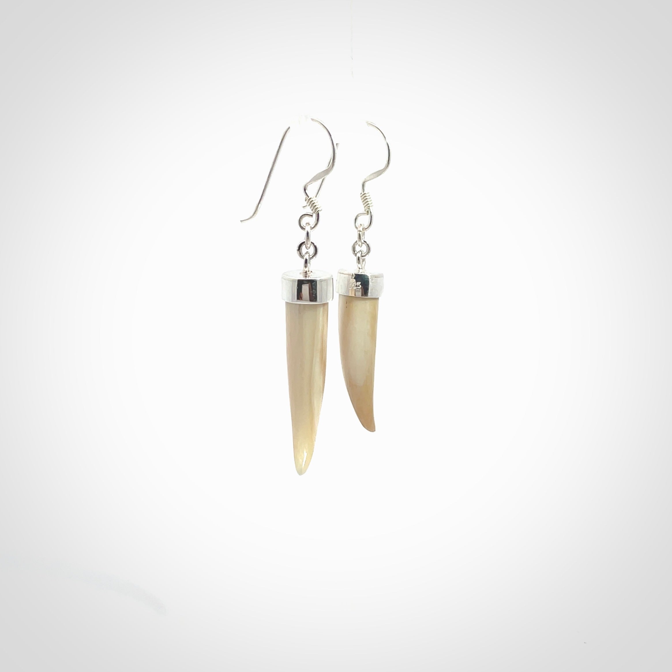 Hand made mammoth tusk drop earrings. Made by NZ Pacific - handmade jewellery for sale online. Woolly Mammoth Tusk fang style earrings, packaged in a woven kete pouch.