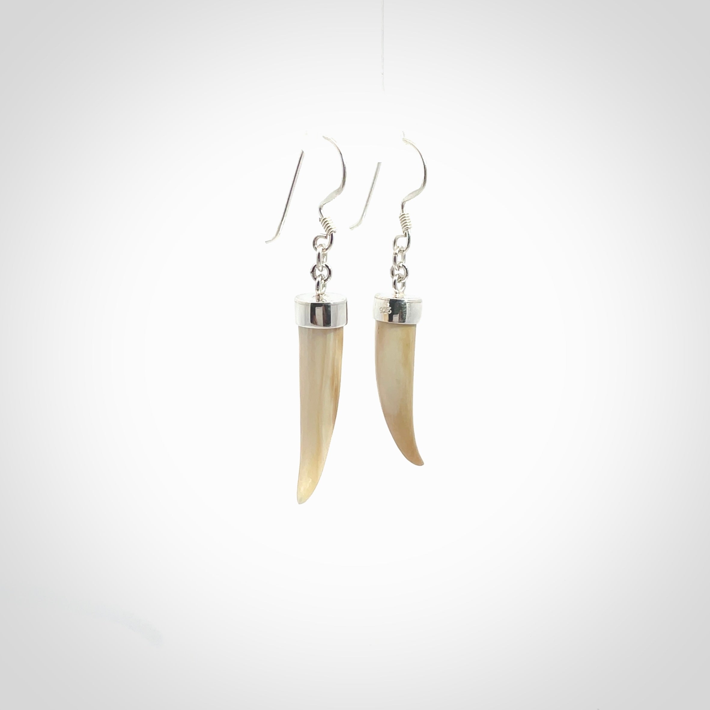 Hand made mammoth tusk drop earrings. Made by NZ Pacific - handmade jewellery for sale online. Woolly Mammoth Tusk fang style earrings, packaged in a woven kete pouch.