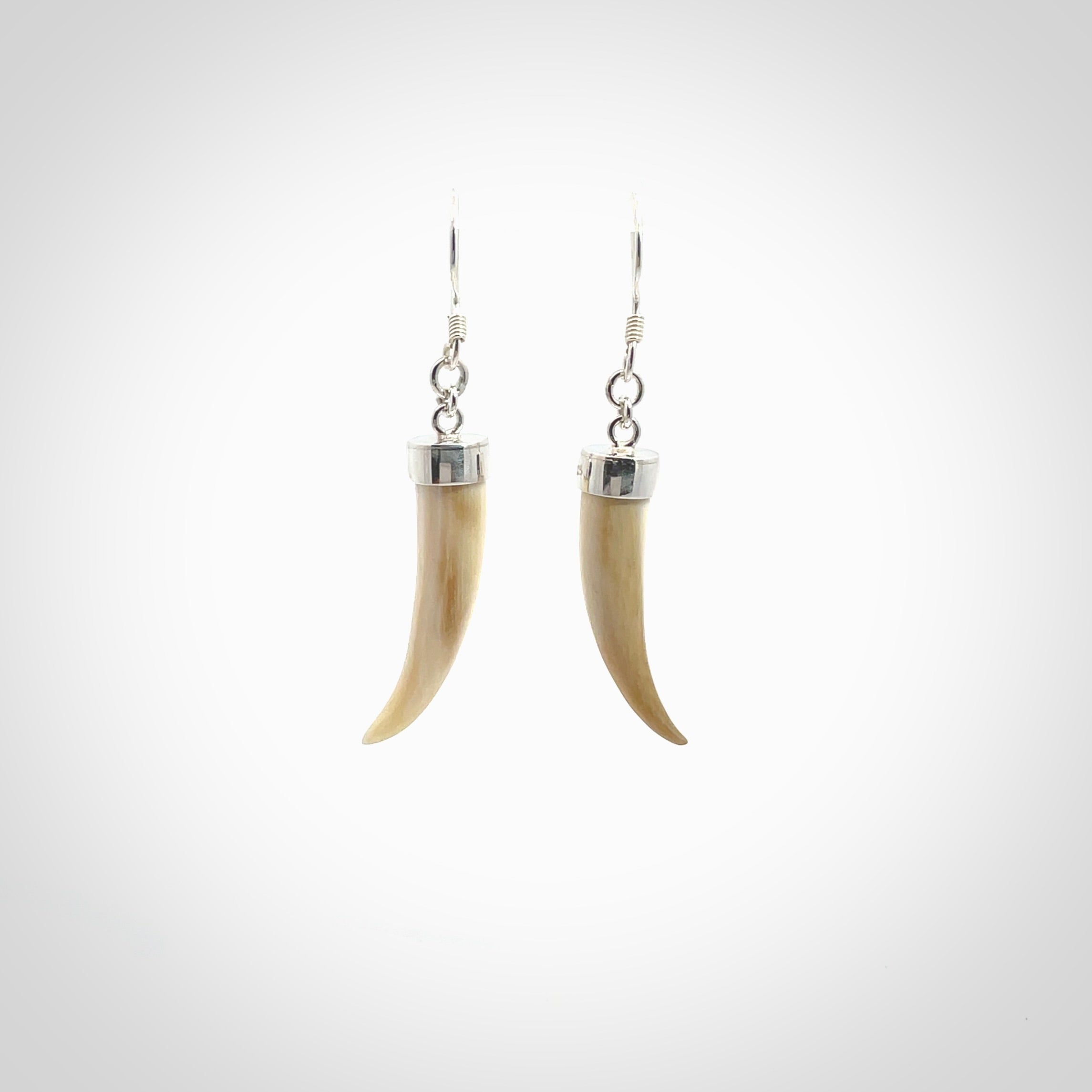 Hand made mammoth tusk drop earrings. Made by NZ Pacific - handmade jewellery for sale online. Woolly Mammoth Tusk fang style earrings, packaged in a woven kete pouch.