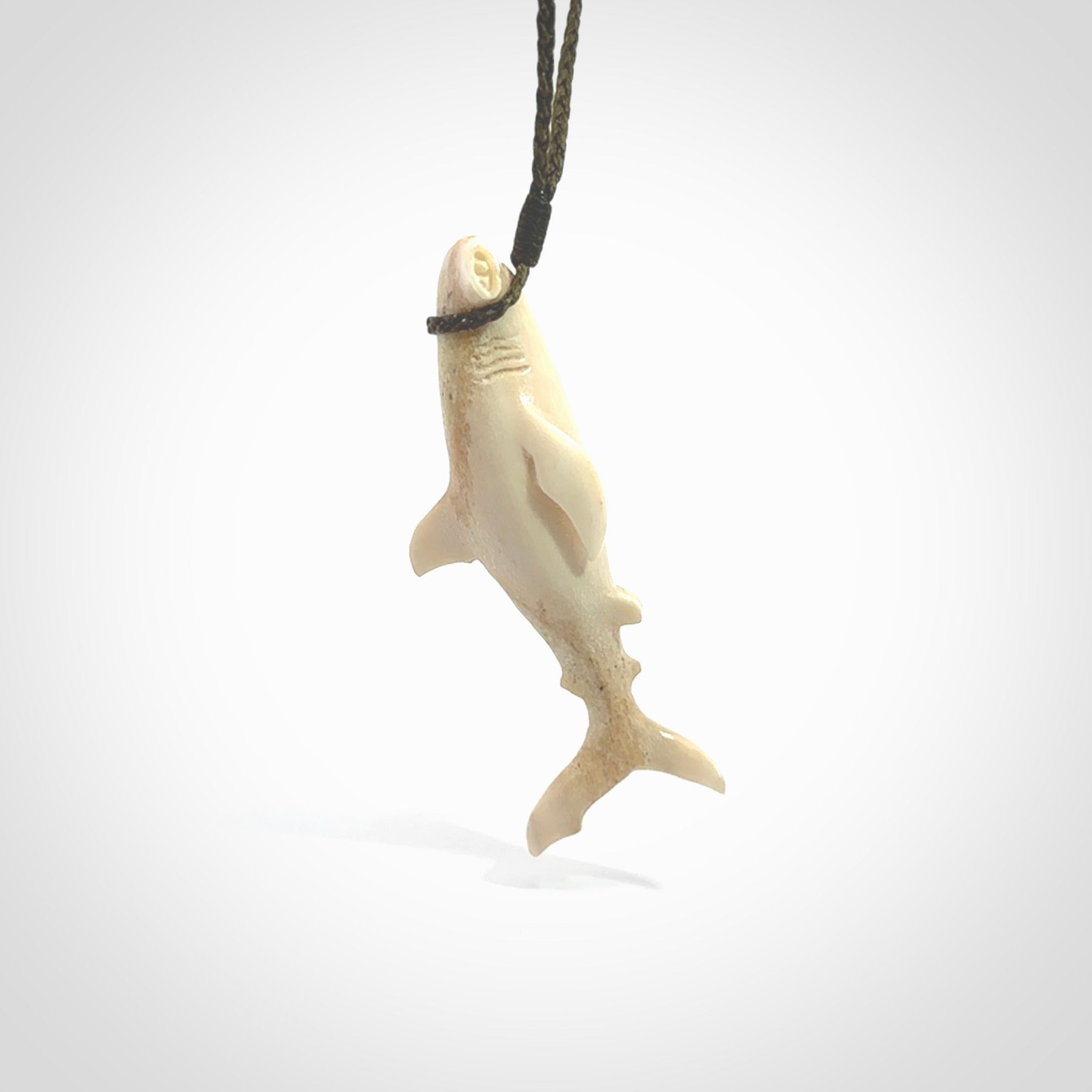 Winghead or hammerhead shark pendant. Handcarved from deer antler by NZ Pacific. Handcarved bone jewellery for sale online. Provided with adjustable olive cord.