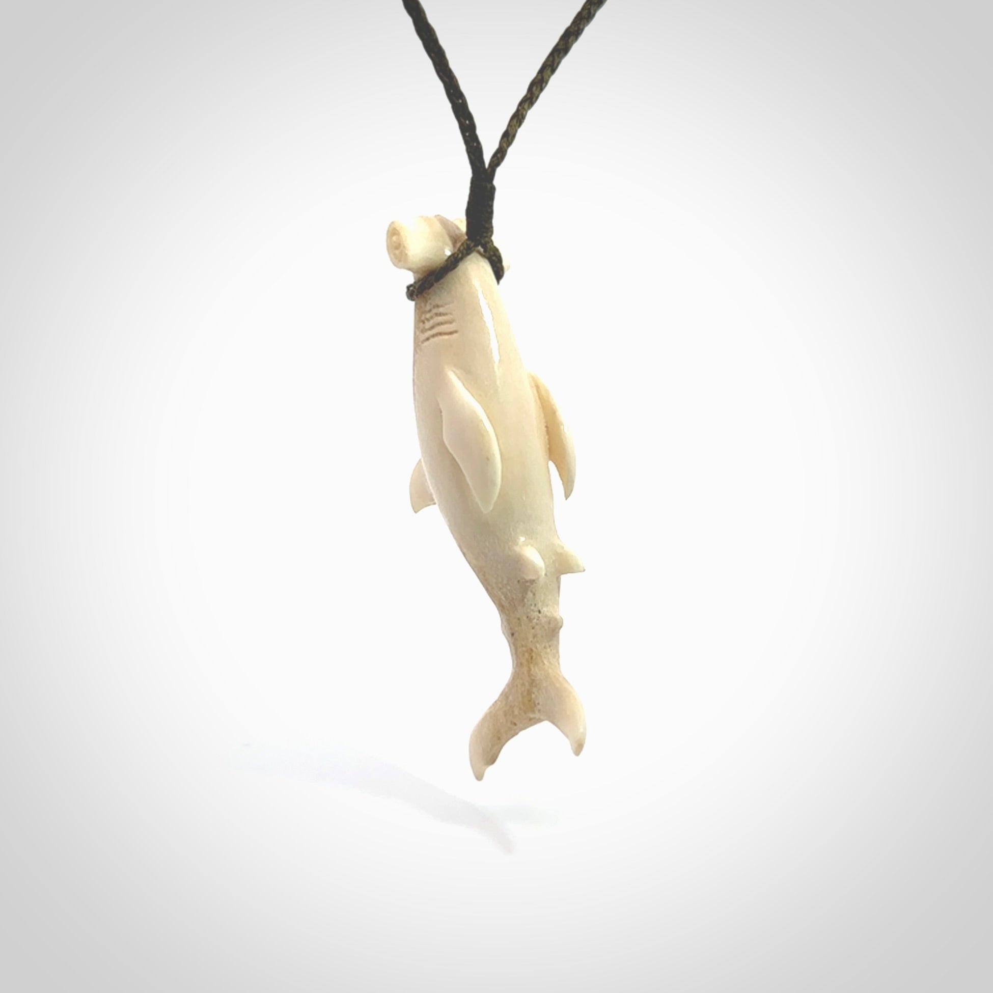 Winghead or hammerhead shark pendant. Handcarved from deer antler by NZ Pacific. Handcarved bone jewellery for sale online. Provided with adjustable olive cord.