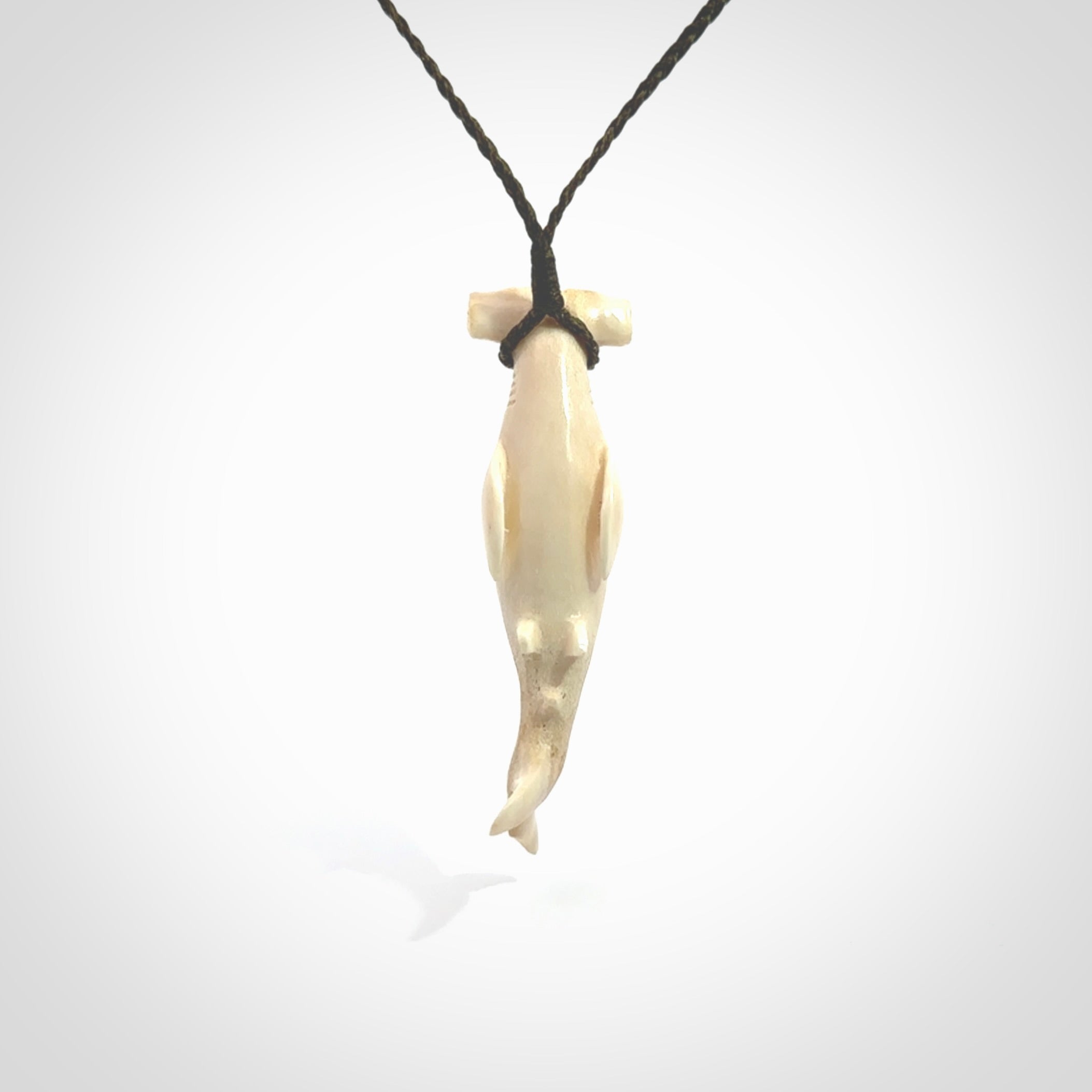 Winghead or hammerhead shark pendant. Handcarved from deer antler by NZ Pacific. Handcarved bone jewellery for sale online. Provided with adjustable olive cord.