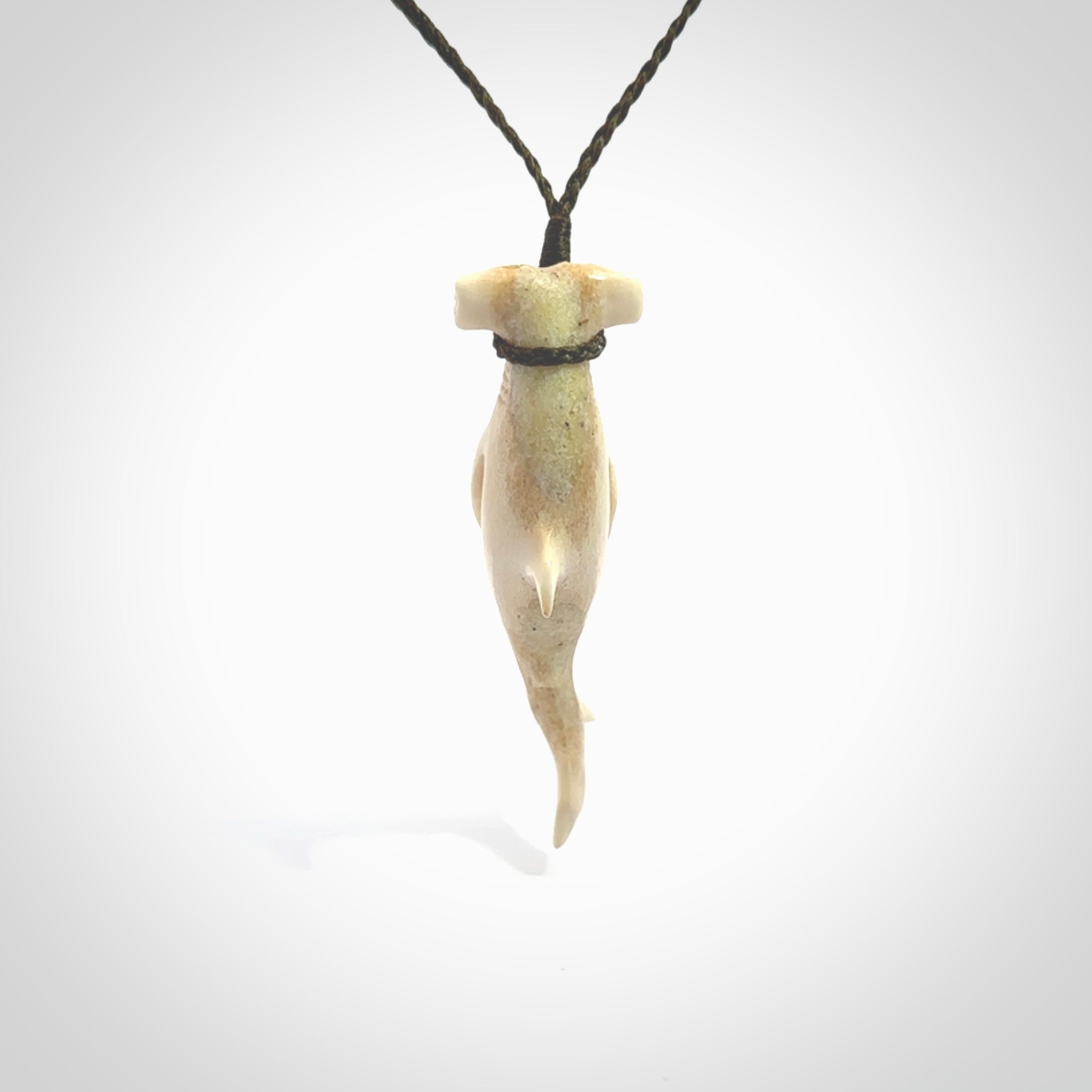 Winghead or hammerhead shark pendant. Handcarved from deer antler by NZ Pacific. Handcarved bone jewellery for sale online. Provided with adjustable olive cord.