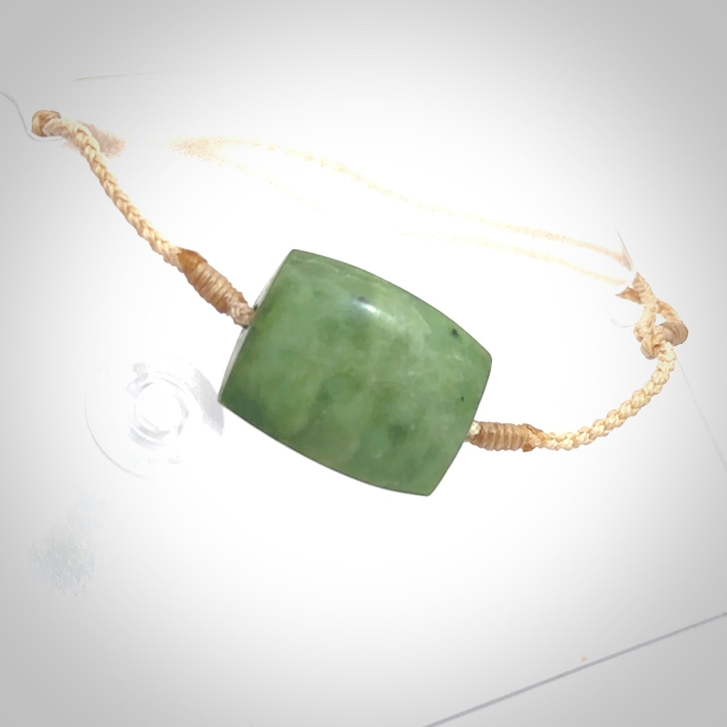 Hand carved New Zealand Jade adjustable armband. Hand made by Ric Moor, this beautiful jade bracelet has a beige adjustable cord. One only.