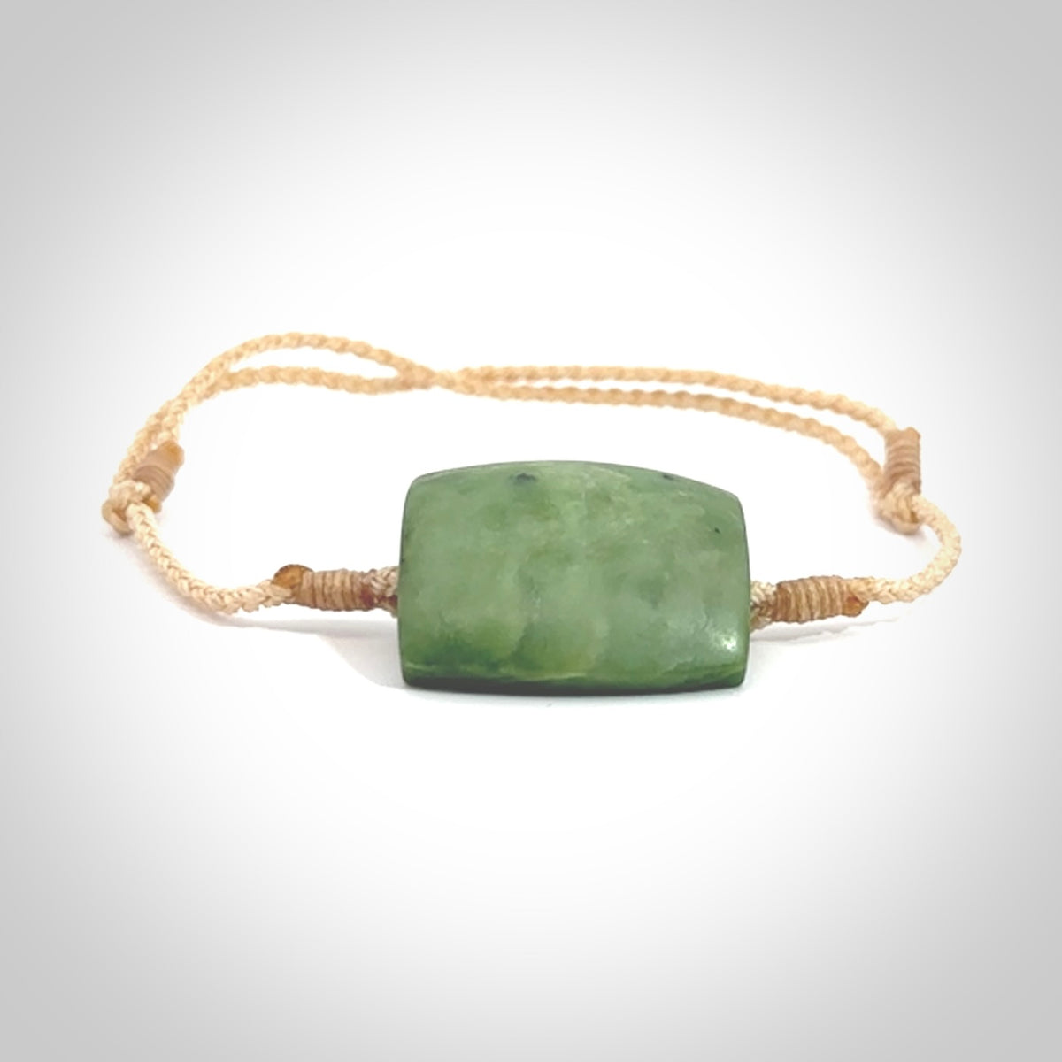 Hand carved New Zealand Jade adjustable armband. Hand made by Ric Moor, this beautiful jade bracelet has a beige adjustable cord. One only.