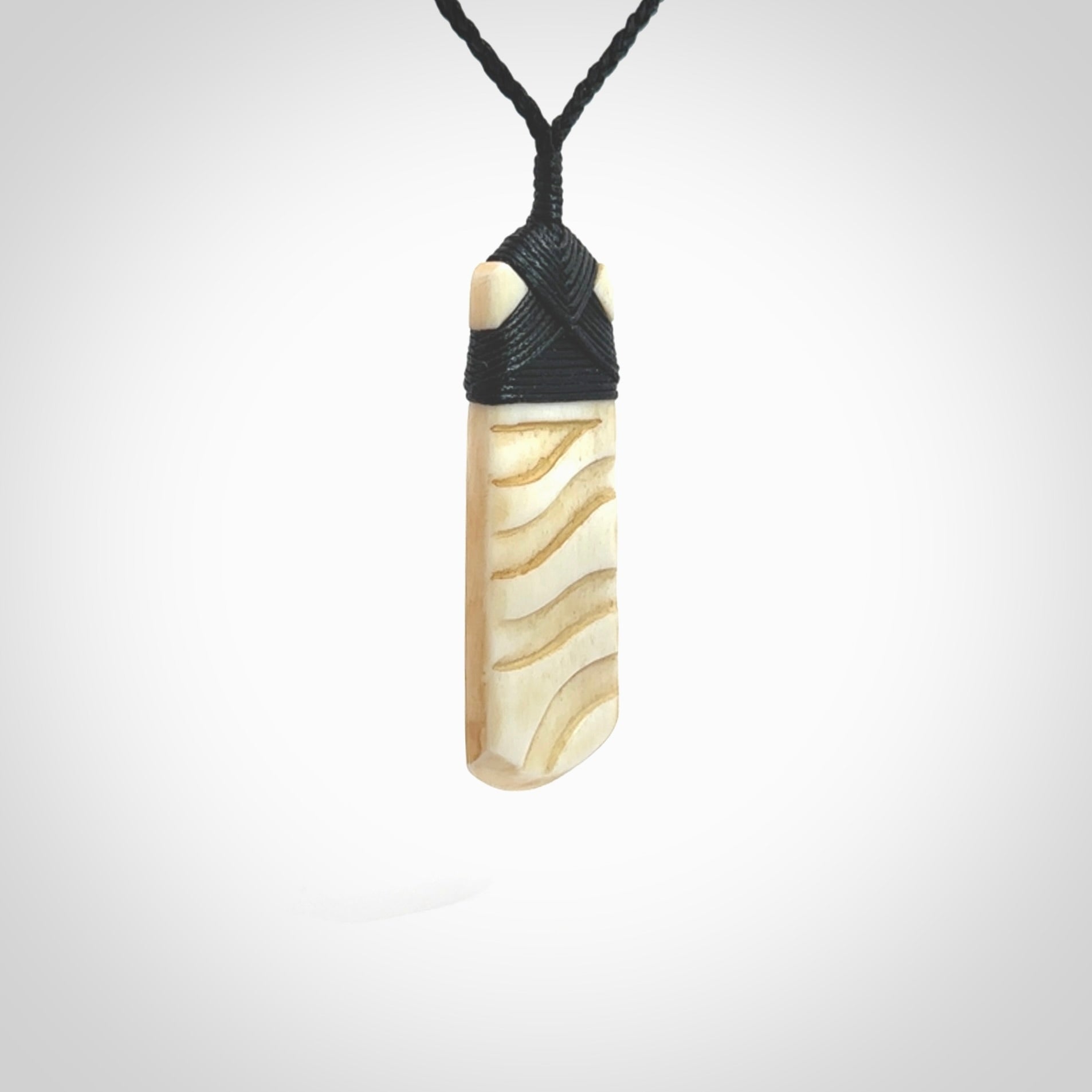 Hand carved Bone toki by Yuri Terenyi. Hand carved for NZ Pacific. Hand carved bone jewellery for sale online. Unique handmade jewellery.