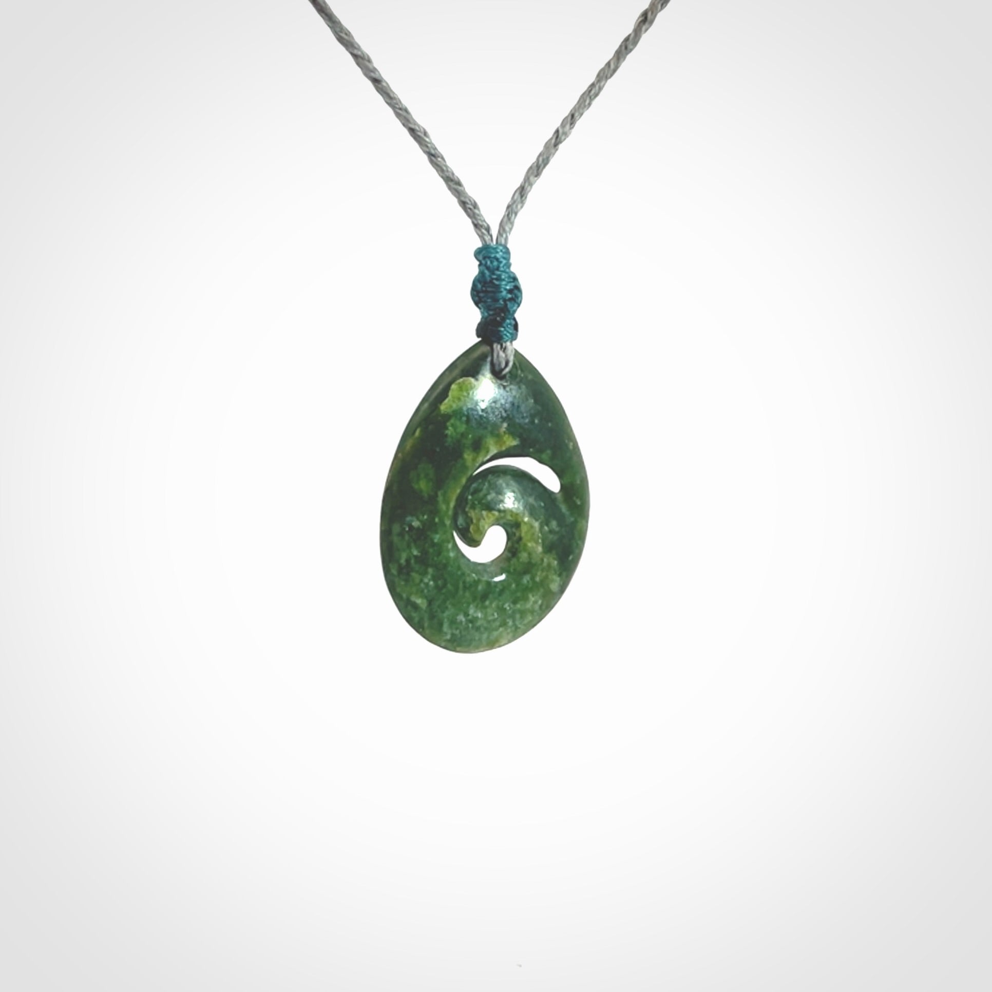 Hand carved New Zealand jade koru drop pendant. Made by NZ Pacific.Hand carved New Zealand jade koru drop pendant. Made by NZ Pacific.