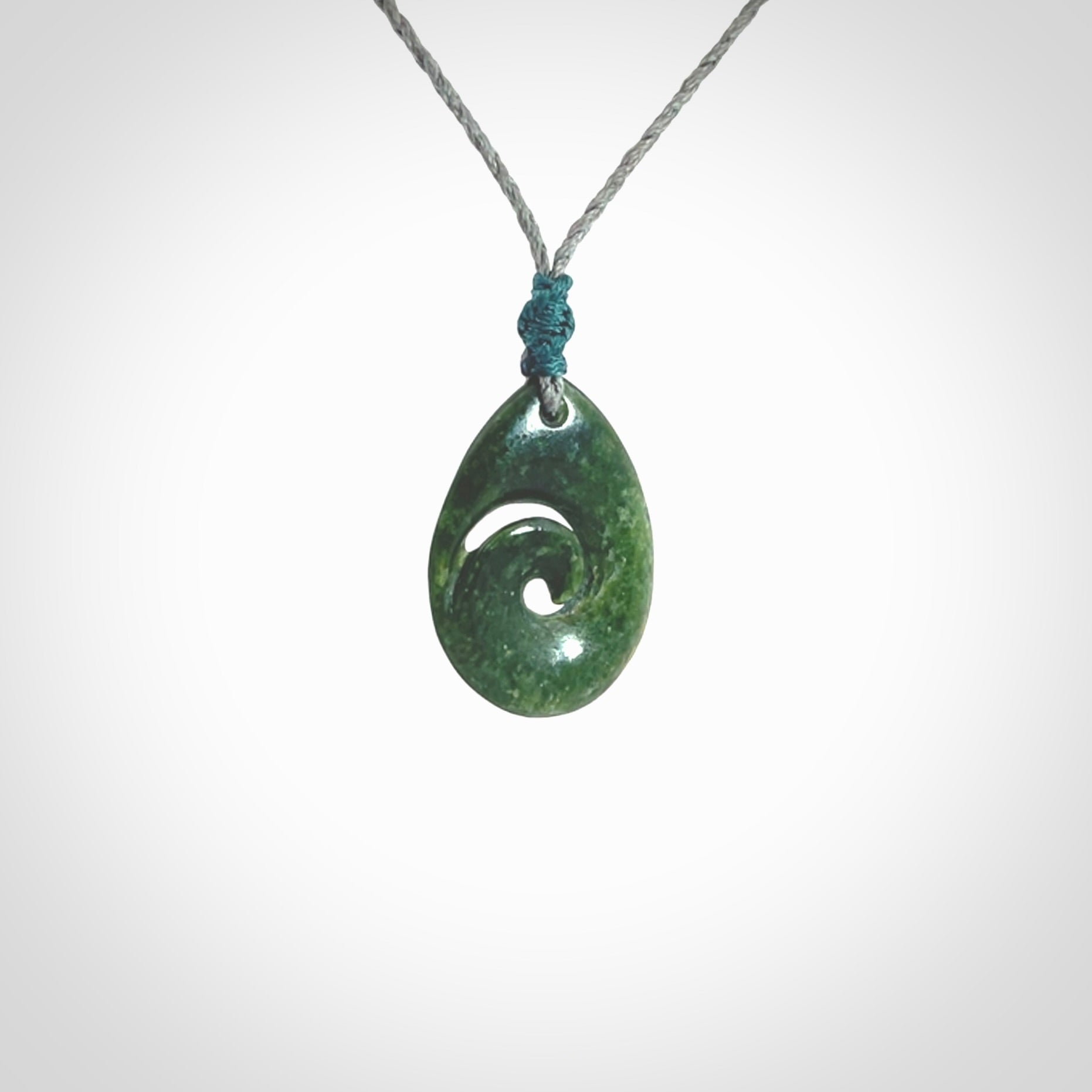 Hand carved New Zealand jade koru drop pendant. Made by NZ Pacific.Hand carved New Zealand jade koru drop pendant. Made by NZ Pacific.