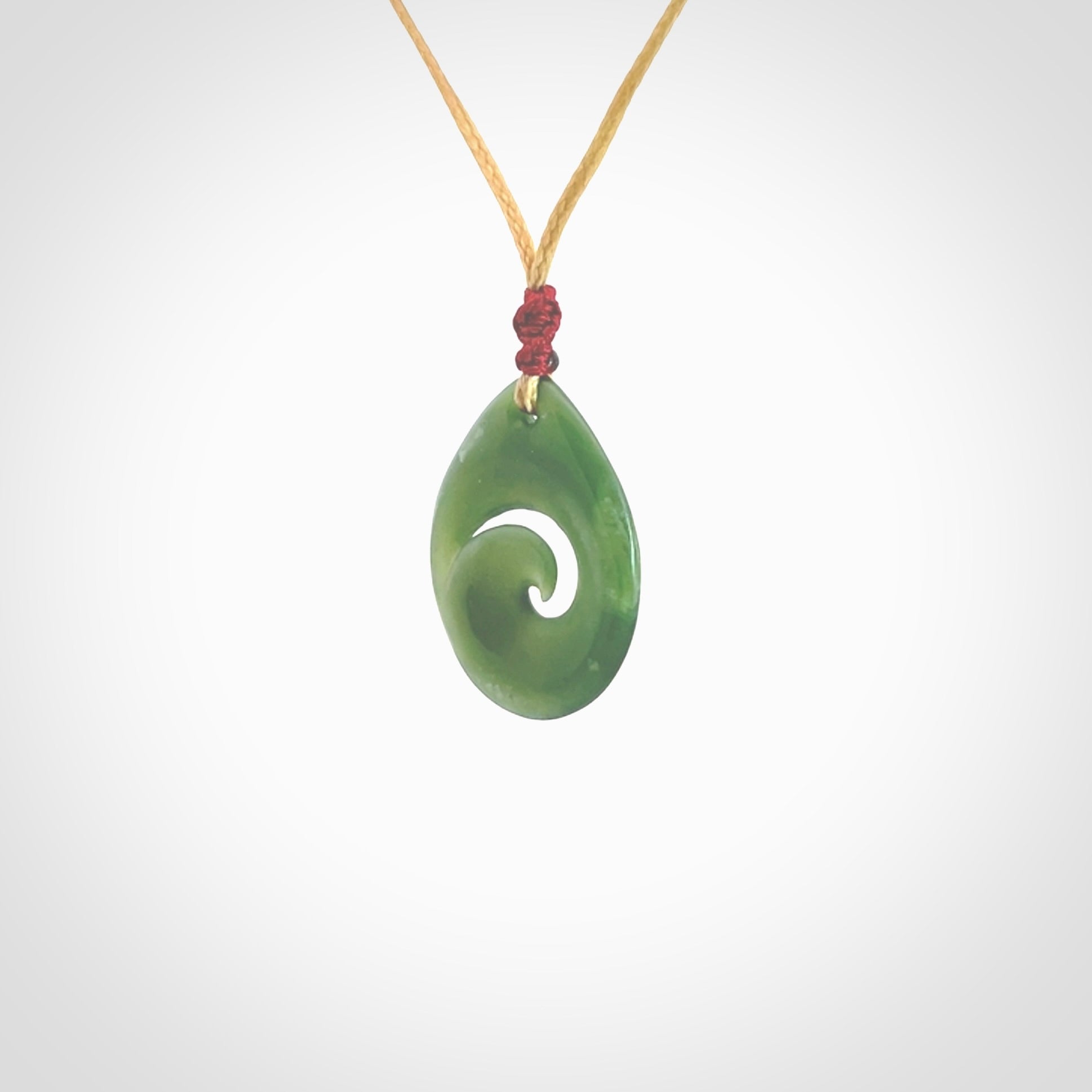 Hand carved New Zealand jade koru drop pendant. Made by NZ Pacific.Hand carved New Zealand jade koru drop pendant. Made by NZ Pacific.