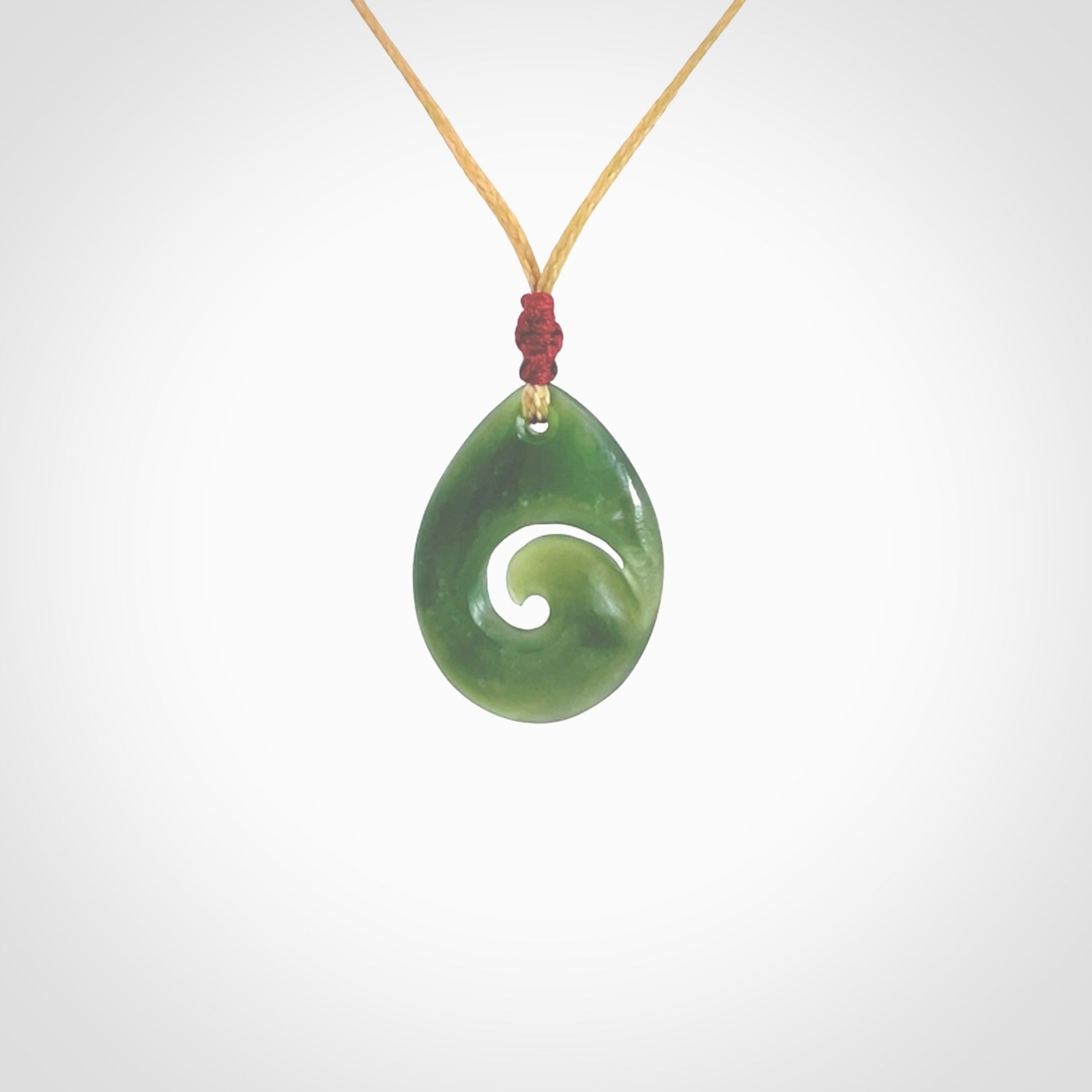 Hand carved New Zealand jade koru drop pendant. Made by NZ Pacific.Hand carved New Zealand jade koru drop pendant. Made by NZ Pacific.