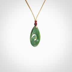 Hand carved New Zealand jade koru drop pendant. Made by NZ Pacific.Hand carved New Zealand jade koru drop pendant. Made by NZ Pacific.