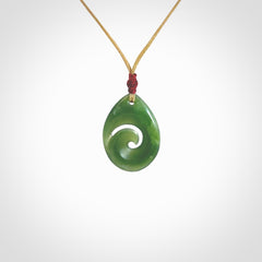 Hand carved New Zealand jade koru drop pendant. Made by NZ Pacific.Hand carved New Zealand jade koru drop pendant. Made by NZ Pacific.