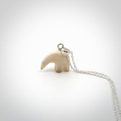 Hand made woolly mammoth tusk sea bear necklace with Sterling Silver. Mammoth tusk polar bear pendant with Sterling silver surround and chain. Made by NZ Pacific and sale online only.