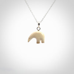 Hand made woolly mammoth tusk sea bear necklace with Sterling Silver. Mammoth tusk polar bear pendant with Sterling silver surround and chain. Made by NZ Pacific and sale online only.