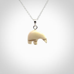 Hand made woolly mammoth tusk sea bear necklace with Sterling Silver. Mammoth tusk polar bear pendant with Sterling silver surround and chain. Made by NZ Pacific and sale online only.