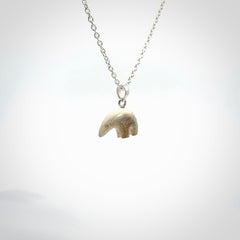 Hand made woolly mammoth tusk sea bear necklace with Sterling Silver. Mammoth tusk polar bear pendant with Sterling silver surround and chain. Made by NZ Pacific and sale online only.