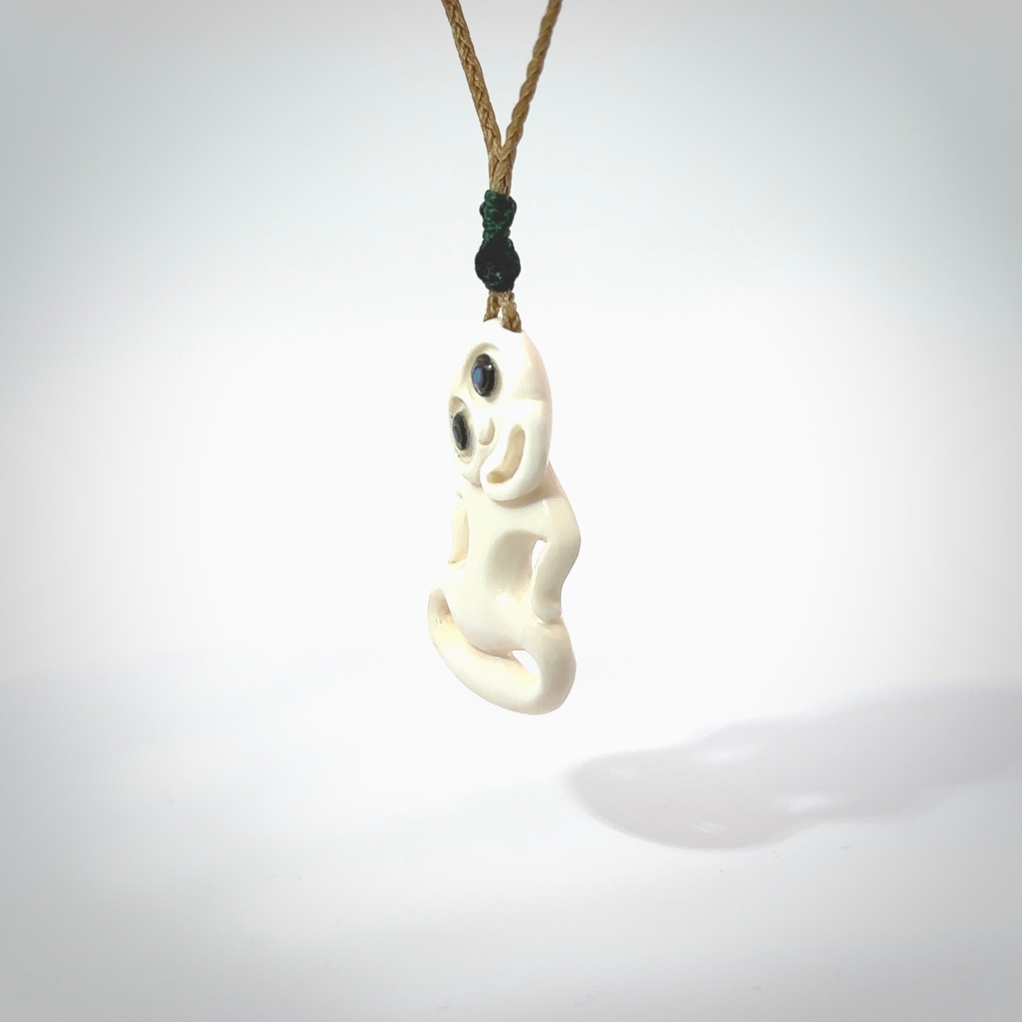 This little bone tiki has been carved to look and feel great. It has pāua shell eyes and is provided with a hand plaited cord. A gorgeous and small traditional piece that is great for children.