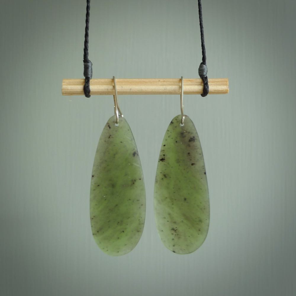 These are stunning large drop shaped jade earrings carved in New Zealand by Darren Hill. It is carved from a semi-translucent light green piece of New Zealand Jade and with Sterling Silver hooks.