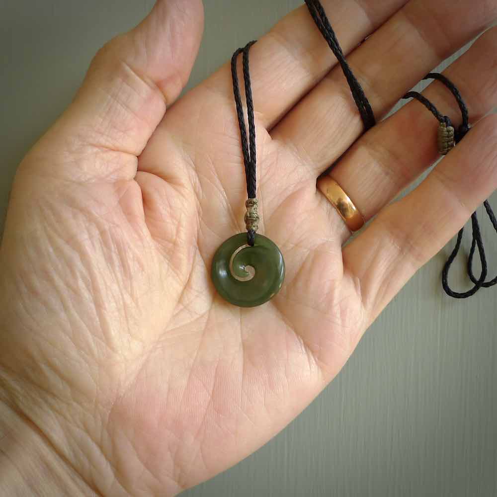 This little pendant is a beautifully carved, small jade koru pendant. Hand Carved for NZ Pacific by Graeme Wylie. Jade jewelry for sale online exclusively with NZ Pacific.