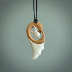 A hand carved bone contemporary bird pendant. The cord is a black colour and is a fixed length. A medium sized hand made contemporary necklace by New Zealand artist Kerry Thompson. Kerry has stained parts of the bone which really add to the dimension of this pendant. One off work of art to wear.