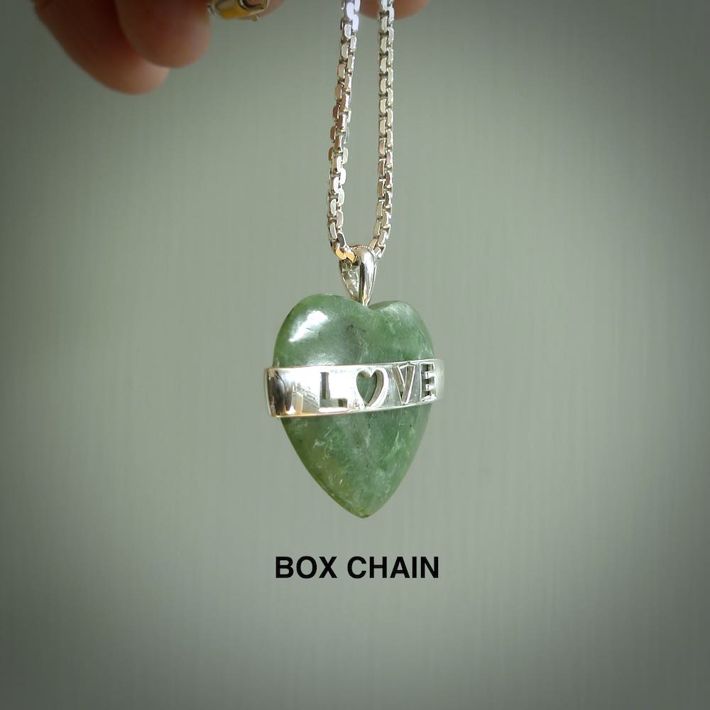 Hand crafted New Zealand jade love heart necklace. This piece has  a sterling silver love written across its' body. This necklace is provided with a sterling silver chain.