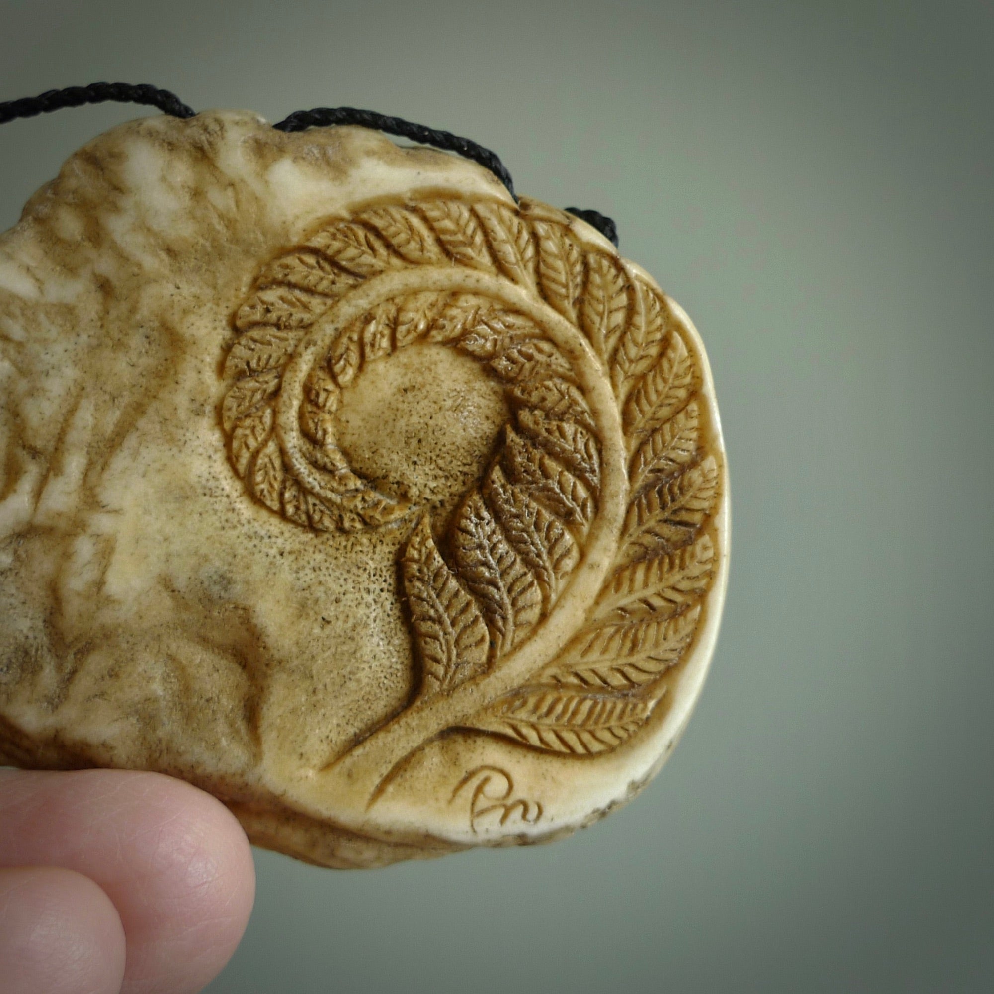 A hand carved kiwi skeleton pendant carved from a piece of deer antler crown. This is a work of art carved by Fumio Noguchi who is renowned for his skill in bone carving. The kiwi is a native bird to New Zealand. This is a great piece representing this very cool bird.