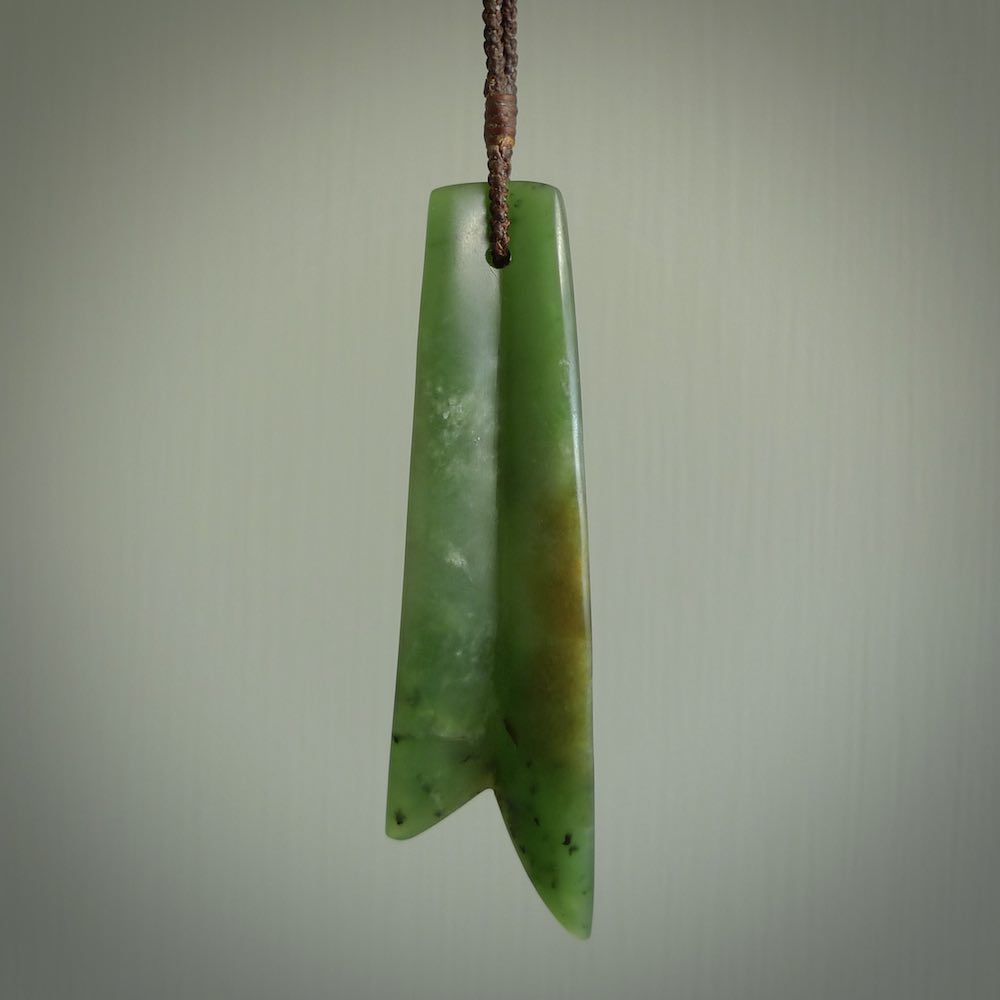 This piece is a fine, delicate pendant. It was carved for us by Ric Moor from a lovely semi-translucent green piece of New Zealand Marsden jade. It is suspended on an dark brown  four plaited braided cord that is length adjustable.