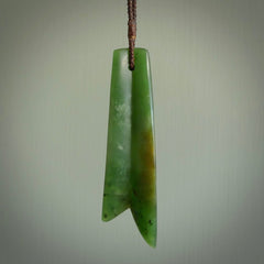 This piece is a fine, delicate pendant. It was carved for us by Ric Moor from a lovely semi-translucent green piece of New Zealand Marsden jade. It is suspended on an dark brown  four plaited braided cord that is length adjustable.