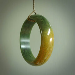 Hand carved jade bangle. Carved from green New Zealand jade. This is a solid jade bangle carved from a single piece of jade. It is polished to a soft shine. the jade is otherwise untreated and completely natural.