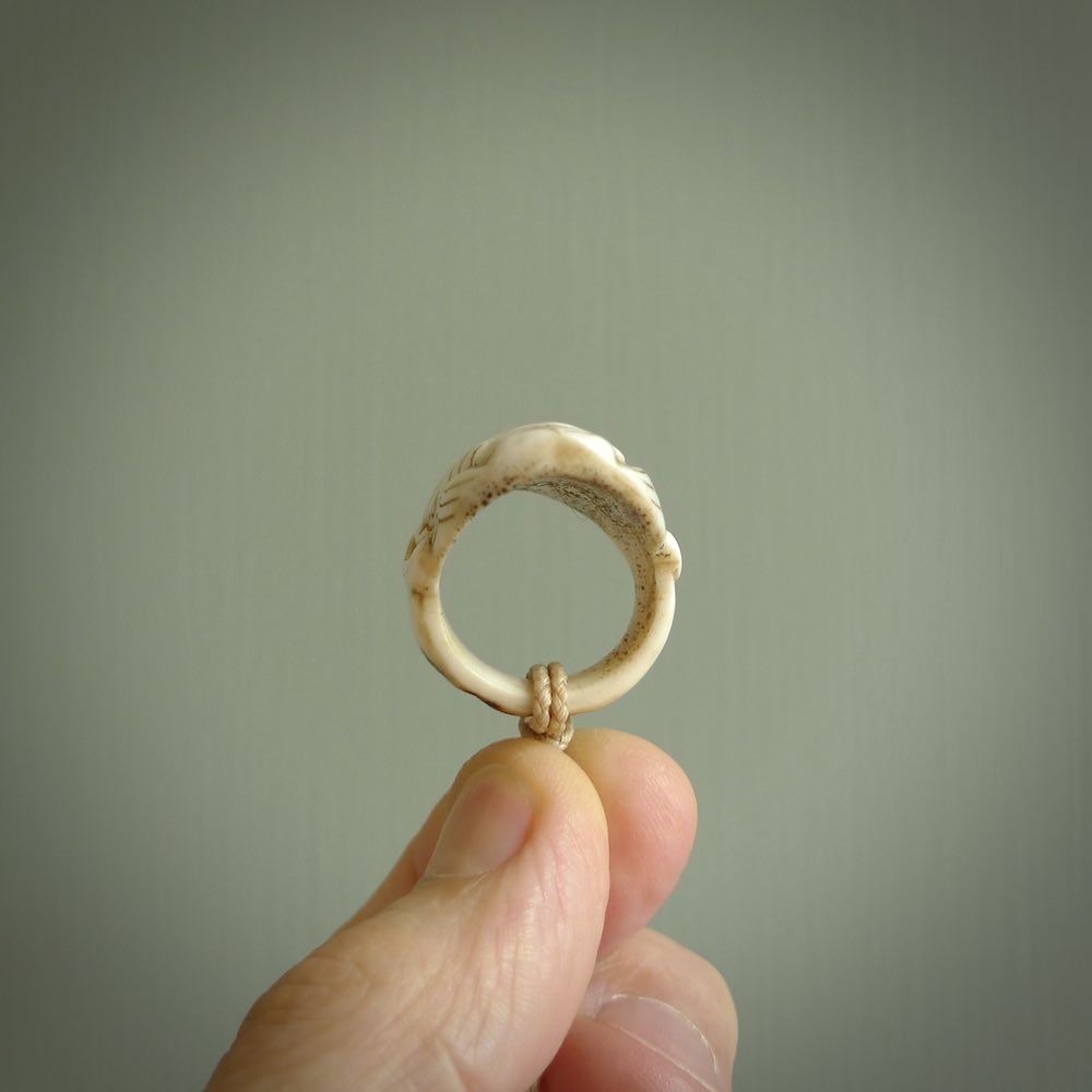 Hand carved Moko man face ring. Made from Red Deer antler in New Zealand. Unique Moko Man ring hand made from deer antler by master bone carver Fumio Noguchi. Spectacular collectable work of art, made to wear. One only ring, delivered to you at no extra cost with express courier.