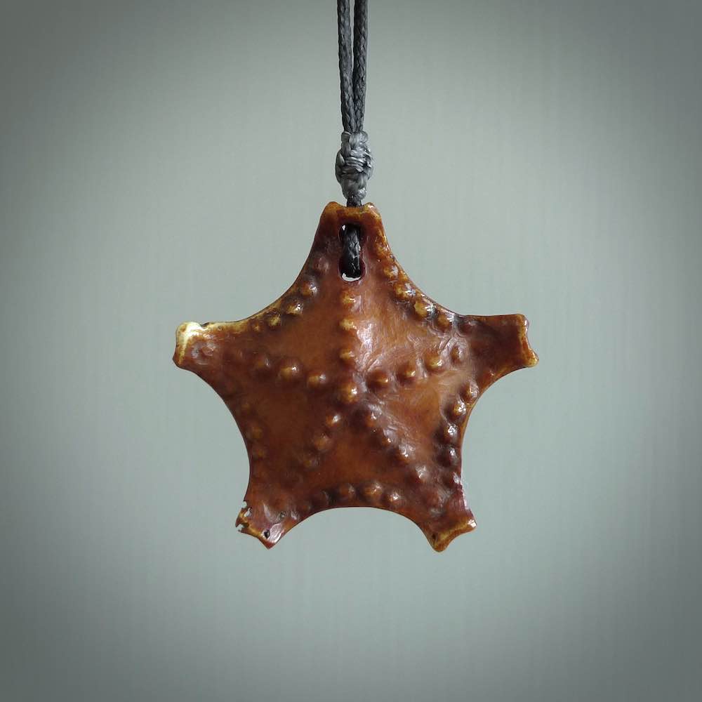 Hand carved bone starfish pendant. Ocean themed pendants carved by NZ Pacific. Moana pendants for sale online. Hand made stained bone sea star by Yuri Terenyi. We provide these starfish on adjustable brown or black cords. Postage is included in the price.