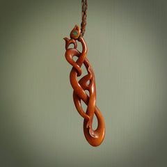 A one off beautiful piece of carved art. We have called this Wrap Around, it was hand carved for us by Yuri Terenyi and is a manaia with twist design pendant. This is a wonderful ethnic bone pendant designed to be worn. It has been stained by a homemade tea dye in a bright gingery brown colour and we have hand plaited an adjustable cord in wapiti and ginger nut colours.