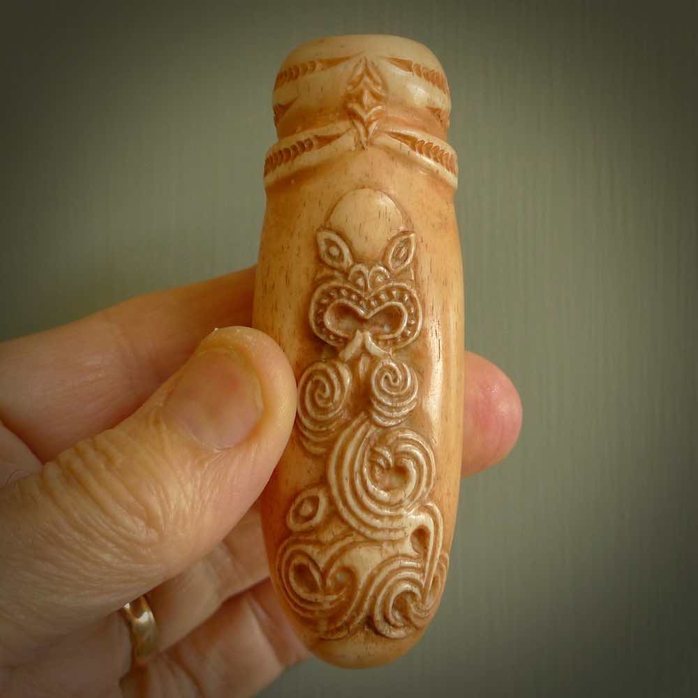 A traditional hand carved Māori flute. This piece is made from bone and is a fully functioning musical instrument and can be played. Beautiful ethnic art hand made by NZ Pacific.