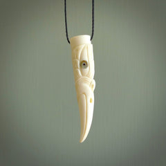 A mythical bird head hand carved from bone with Paua shell eyes. This is a one only bird head with long beak necklace hand made from natural bone with paua shell eyes. This bird head has engravings and is a magnificent piece of art to wear. It is delivered on a black adjustable cord.