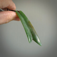 This piece is a fine, delicate pendant. It was carved for us by Ric Moor from a lovely semi-translucent green piece of New Zealand Marsden jade. It is suspended on an dark brown  four plaited braided cord that is length adjustable.