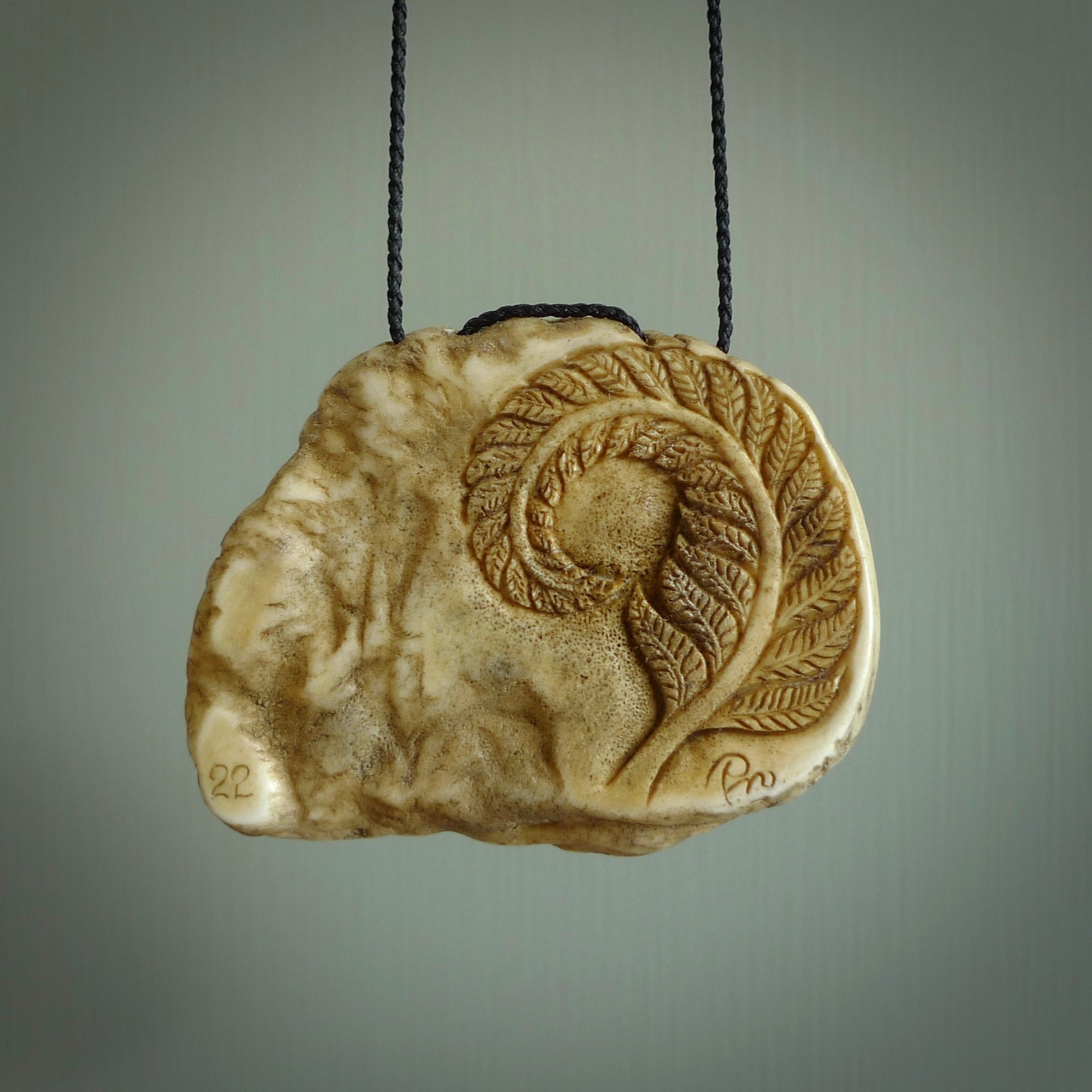 A hand carved kiwi skeleton pendant carved from a piece of deer antler crown. This is a work of art carved by Fumio Noguchi who is renowned for his skill in bone carving. The kiwi is a native bird to New Zealand. This is a great piece representing this very cool bird.